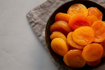 Organic Raw Dry Apricots in a Bowl, top view. Copy space.