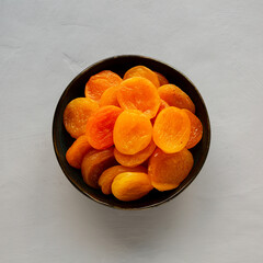 Organic Raw Dry Apricots in a Bowl, top view. Overhead, from above.
