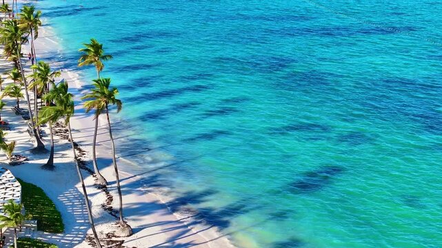 The best beaches in the world. Aerial view of a Bahamian hotel beach on the shores of a blue ocean. White sand, a beautiful beach, tall palm trees. Relaxing with turquoise seawater.