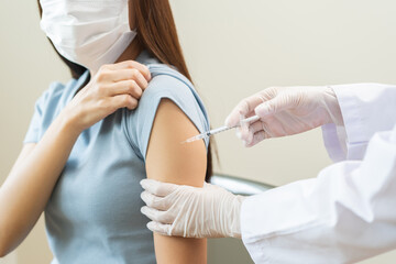 Health care, corona virus, hand of woman nurse, doctor giving syringe vaccine, injection dose on arm sick patient at clinic. Vaccination, immunization disease prevention against flu pandemic influenza