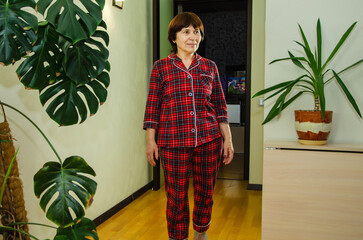 Elderly woman smiling entering bedroom