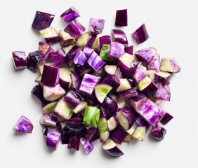 Diced purple and green vegetable pieces scattered on white background