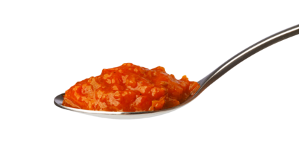 Spoon holding ajvar relish with transparent background