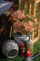 Rustic Floral Arrangement With Vintage Vases and Red Candles Outdoors