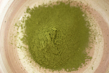 Ceremonial matcha powder in traditional matcha bowl, close-up