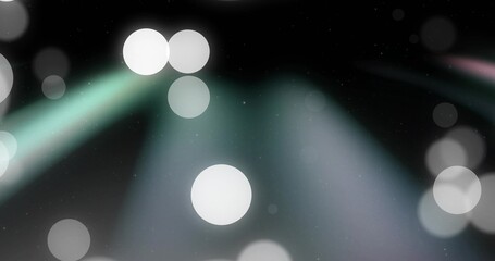 Glowing bright white circular bokeh near center on stage, casting soft teal and lavender beams