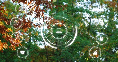 Fototapeta premium Showing futuristic circular HUD overlaying autumn forest canopy, with laptop icon plus edge icons