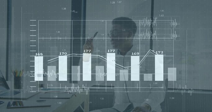 Analyzing businessman in blazer reviewing data and charts at office desk, laptop and data overlay