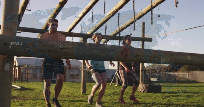 Carrying heavy wooden log three adults in athletic gear walking across obstacle field, visible bib