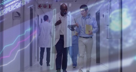 Walking two doctors in lab coats discussing data in hospital corridor, with tablet and yellow file