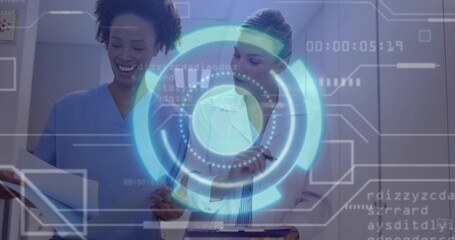 Reviewing papers clinicians in white coat blue scrubs in corridor with clipboard, viewing hologram