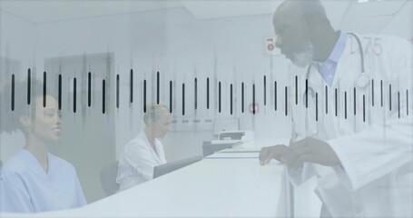 Leaning clinician in white coat and stethoscope speaking at reception with computer, copy space