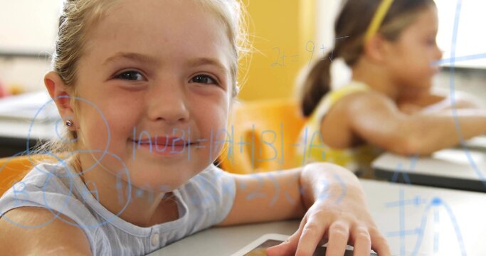 Smiling blonde student resting hand on tablet at classroom desk wearing blue top, math overlay - Powered by Adobe