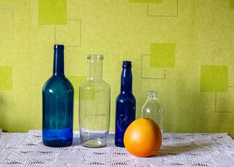 still life with glass bottles and other objects on a green background, season, leisure and objects...