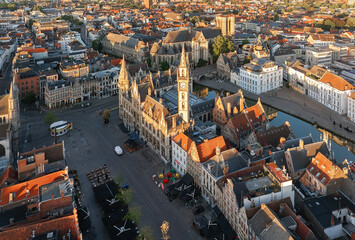 Aerial view of the Ghent City Hall's intricate facade and the Post Plaza's vibrant atmosphere under the golden light, Ghent, Flanders, Belgium.