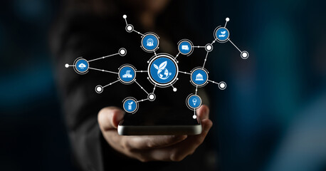 A hand holds a smartphone surrounded by digital icons, representing the integration of technology and communication in modern society. Ideal for tech-related concepts. Tessel