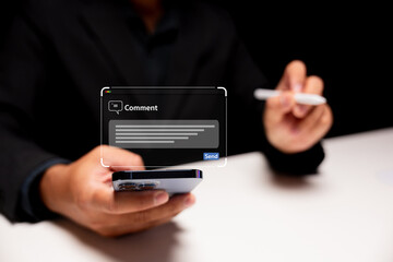 A person in a suit is using a smartphone, preparing to send a comment, with a digital text box displayed above the phone.