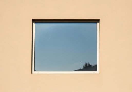 Exterior wall detail with a minimalist square window and reflected sky