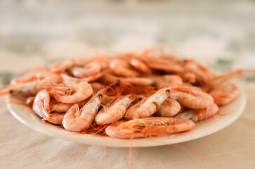 Plate of cooked prawns on the table ready to eat with the family, recipes with prawns and langoustines