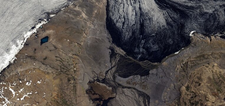 Dramatic Aerial View of Glacial Edge Meeting Volcanic Earth in Iceland