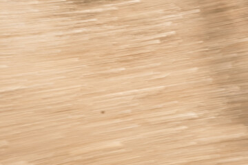 A blurry image of a wooden surface with a few lines and a spot