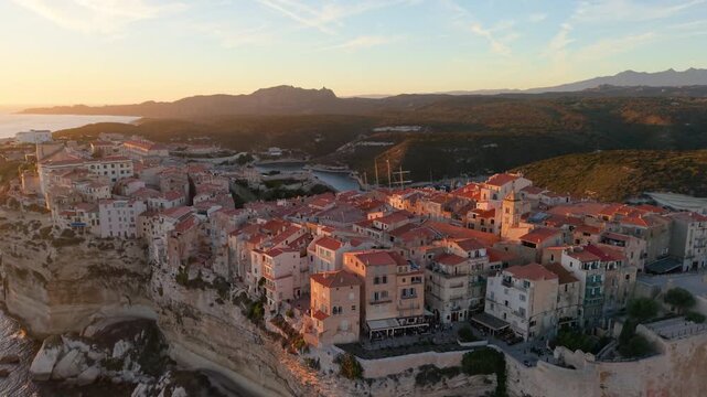 Aerial view of coastal sunset City, peaceful mediterranean coastal community with terracotta roofs during sunset. Bonifacio. France