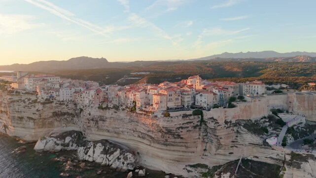 Aerial view of coastal sunset City, peaceful mediterranean coastal community with terracotta roofs during sunset. Bonifacio. France
