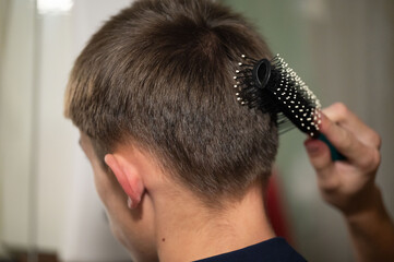 Carefully styling my hair at home in the warm afternoon light, surrounded by the cozy atmosphere of my inviting bathroom