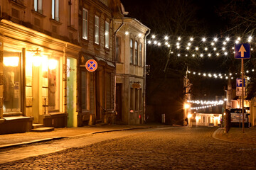 colorful and bright autumn landscape from the city in dark autumn, illuminated city streets in an autumn evening, beautiful lights, Cesis, Latvia