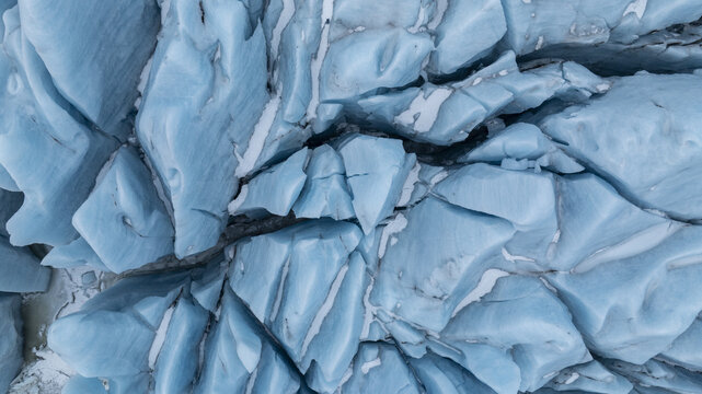 Aerial view of a glacier's fractured blue ice reflecting the sky's light, creating a mosaic of textures and tones, Jokulsarlon, Sveitarfelagid Hornafjordur, Iceland.