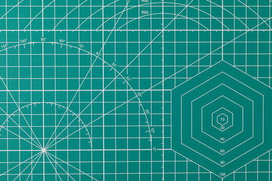 Green cutting mat surface with grid and measurement lines