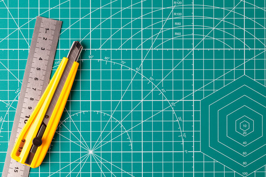 Cutting mat with utility knife and metal ruler