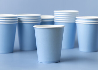 Disposable light blue paper cups closeup, mockup, copy space. No plastic biodegradable single-use