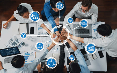 A diverse group of professionals collaborates in a modern office, showcasing team unity and growth through digital icons representing innovation and strategic alignment. Amity