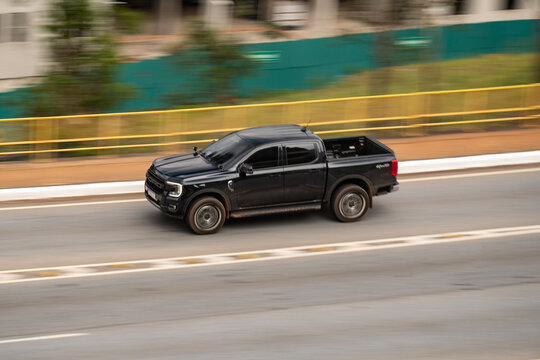 Black Ford Ranger side view in movement, Pickup truck driving on road