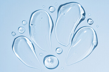 transparent gel texture on a blue background. cosmetic cream stroke, face care gel. Creamy foundation or moisturizer