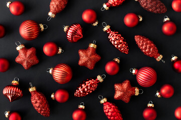 Red Christmas Ornaments on Black Background Festive Holiday Flat lay with Stars, Baubles, and Pinecone Decorations in Elegant Minimal Style for Cards, Banners, Social Media, and Seasonal Designs