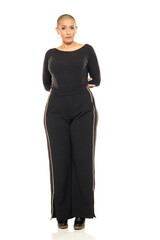 Confident bald woman in black outfit posing full body, concept for empowerment, fashion, diversity,...