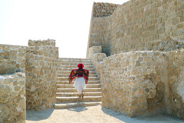 Female Visiting the Ancient Bahrain Fort, a Remarkable UNESCO World Heritage Site in Manama, Capital City of Bahrain