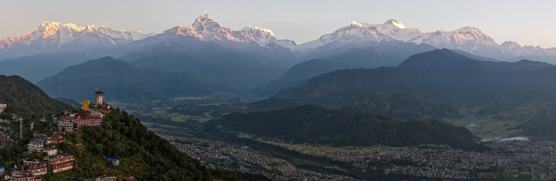 Aerial view of the golden Ganesh statue and the observation tower stand majestically against the backdrop of the snow-capped Annapurna range, Pokhara, Gandaki Province, Nepal. - Powered by Adobe