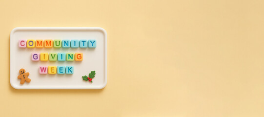 Community giving week message in colorful blocks with gingerbread on yellow background