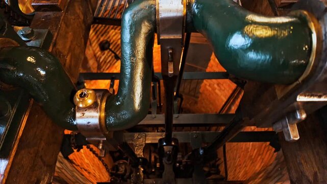 Close-up view of an old industrial steam engine operating indoors