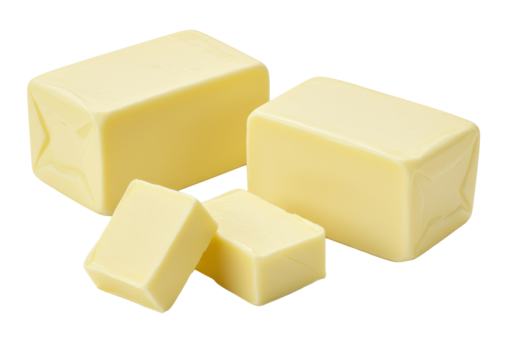 Three pale yellow creamy butter pieces (one large block, two irregular chunks) on a pristine transparent background with ample copy space. Appetizing food photography concept