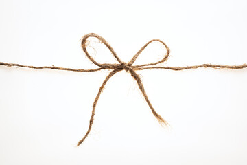 String tied in a bow on a white background