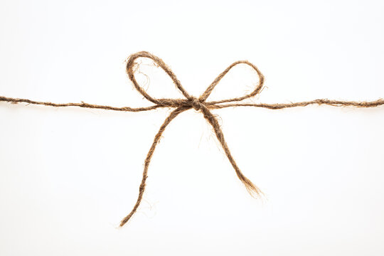 String tied in a bow on a white background