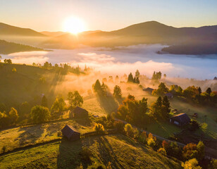 Sunrise bathes fog-covered village in golden light, creating a serene rural landscape at dawn