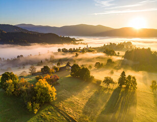 Sunrise over a fog-covered village with golden light in a serene rural landscape