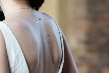 Woman wearing backless dress with elegant necklace