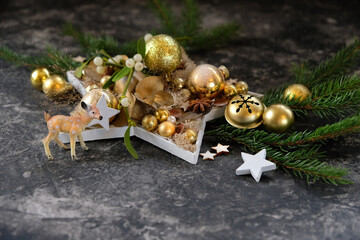 Beautiful Christmas background. deer toy figurine, decorative star and fir branches on abstract...