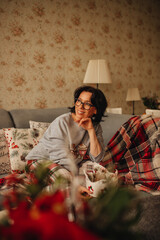 A woman sitting on a sofa during the Christmas period